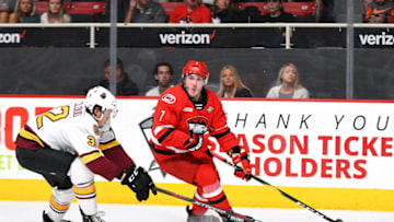 CHARLOTTE, NC - JUNE 01: Charlotte Checkers left wing Aleksi Saarela (7) keeps the puck out of reach from Chicago Wolves defenseman Zach Whitecloud (32) during game one of the Calder Cup finals between the Chicago Wolves and the Charlotte Checkers on June 01, 2019 at Bojangles Coliseum in Charlotte,NC.(Photo by Dannie Walls/Icon Sportswire via Getty Images)