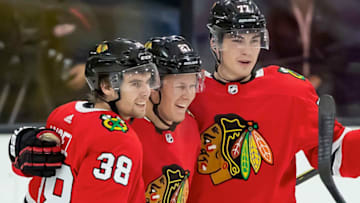 TRAVERSE CITY, MI - SEPTEMBER 06: Adam Boqvist #27 of the Chicago Blackhawks celebrates his game-winning goal against the Detroit Red Wings in overtime with teammates Brandon Hagel #38 and Kirby Dach #77 during Day 1 of the NHL Prospects Tournament at Centre Ice Arena on September 6, 2019 in Traverse City, Michigan. (Photo by Dave Reginek/NHLI via Getty Images)