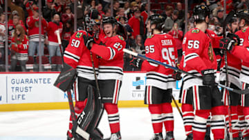 CHICAGO, IL - JANUARY 05: Adam Boqvist #27 and goalie Corey Crawford #50 of the Chicago Blackhawks celebrate after defeating the Detroit Red Wings 4-2 at the United Center on January 5, 2020 in Chicago, Illinois. (Photo by Chase Agnello-Dean/NHLI via Getty Images)
