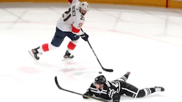 CHICAGO, IL - JANUARY 21: Vincent Trocheck #21 of the Florida Panthers grabs the puck away from Adam Boqvist #27 of the Chicago Blackhawks in the first period at the United Center on January 21, 2020 in Chicago, Illinois. (Photo by Chase Agnello-Dean/NHLI via Getty Images)