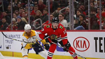 CHICAGO, ILLINOIS - FEBRUARY 21: Dylan Strome #17 of the Chicago Blackhawks controls the puck under pressure from Ryan Ellis #4 of the Nashville Predators at the United Center on February 21, 2020 in Chicago, Illinois. (Photo by Jonathan Daniel/Getty Images)
