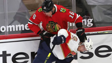 CHICAGO, ILLINOIS - MARCH 23: Juho Lammikko #83 of the Florida Panthers is pressured by Nikita Zadorov #16 of the Chicago Blackhawks along the boards at the United Center on March 23, 2021 in Chicago, Illinois. The Blackhawks defeated the Panthers 3-2. (Photo by Jonathan Daniel/Getty Images)