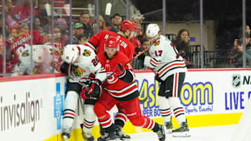 Oct 26, 2019; Raleigh, NC, USA; Carolina Hurricanes right wing Sebastian Aho (20) checks Chicago Blackhawks center Ryan Carpenter (22) during the second period at PNC Arena. Mandatory Credit: James Guillory-USA TODAY Sports