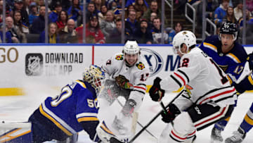 Feb 25, 2020; St. Louis, Missouri, USA; St. Louis Blues goaltender Jordan Binnington (50) and left wing Jaden Schwartz (17) defend the net against Chicago Blackhawks center Dylan Strome (17) and left wing Alex DeBrincat (12) during the second period at Enterprise Center. Mandatory Credit: Jeff Curry-USA TODAY Sports