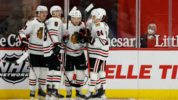 Feb 17, 2021; Detroit, Michigan, USA; Chicago Blackhawks left wing Philipp Kurashev (23) is congratulated by teammates after scoring against the Detroit Red Wings in the second period at Little Caesars Arena. Mandatory Credit: Rick Osentoski-USA TODAY Sports