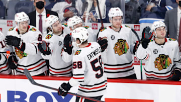 Nov 5, 2021; Winnipeg, Manitoba, CAN; Chicago Blackhawks right wing MacKenzie Entwistle (58) celebrates his third period goal against the Winnipeg Jets at Canada Life Centre. Mandatory Credit: James Carey Lauder-USA TODAY Sports