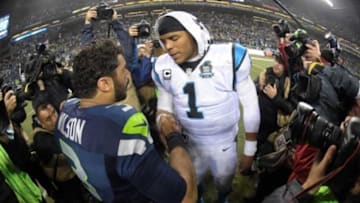 January 10, 2015; Seattle, WA, USA; Seattle Seahawks quarterback Russell Wilson (3) meets with Carolina Panthers quarterback Cam Newton (1) following the 31-17 victory in the 2014 NFC Divisional playoff football game at CenturyLink Field. Mandatory Credit: Kirby Lee-USA TODAY Sports
