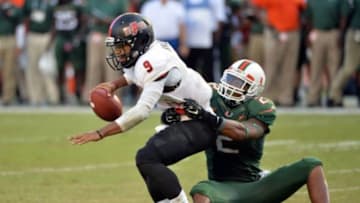 Sep 13, 2014; Miami Gardens, FL, USA; Miami Hurricanes defensive back Deon Bush (2) tackles Arkansas State Red Wolves quarterback Fredi Knighten (9) during the second half at Sun Life Stadium. Miami won 41-20. Mandatory Credit: Steve Mitchell-USA TODAY Sports
