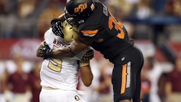 Aug 30, 2014; Arlington, TX, USA; Oklahoma State Cowboys defensive end Emmanuel Ogbah (38) tackles Florida State Seminoles quarterback Jameis Winston (5) during the second quarter at AT&T Stadium. Mandatory Credit: Matthew Emmons-USA TODAY Sports