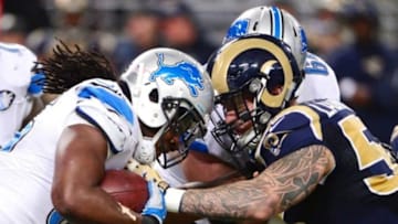 Dec 13, 2015; St. Louis, MO, USA; Detroit Lions running back Joique Bell (35) is stopped by St. Louis Rams middle linebacker James Laurinaitis (55) during the second half at the Edward Jones Dome. The Rams defeated the Lions 21-14. Mandatory Credit: Jeff Curry-USA TODAY Sports