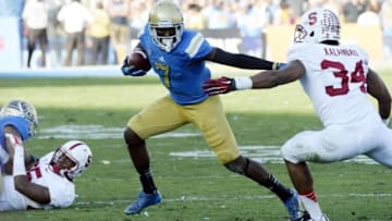 Nov 28, 2014; Pasadena, CA, USA; UCLA Bruins wide receiver Devin Fuller (7) runs against Stanford Cardinal linebacker Peter Kalambayi (34) during the second half of the game at Rose Bowl. Mandatory Credit: Richard Mackson-USA TODAY Sports