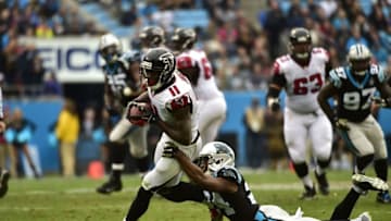 Nov 16, 2014; Charlotte, NC, USA; Atlanta Falcons wide receiver Julio Jones (11) with the ball as Carolina Panthers cornerback Josh Norman (24) defends in the second quarter at Bank of America Stadium. Mandatory Credit: Bob Donnan-USA TODAY Sports