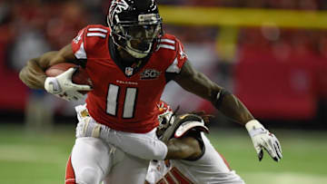 Nov 1, 2015; Atlanta, GA, USA; Atlanta Falcons wide receiver Julio Jones (11) breaks a tackle by Tampa Bay Buccaneers cornerback Mike Jenkins (24) during the first half at the Georgia Dome. The Buccaneers defeated the Falcons 23-20 in over time. Mandatory Credit: Dale Zanine-USA TODAY Sports