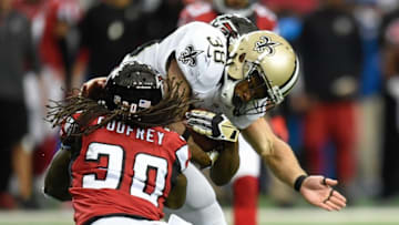 Jan 3, 2016; Atlanta, GA, USA; New Orleans Saints running back Travaris Cadet (38) is tackled by Atlanta Falcons free safety Charles Godfrey (30) during the first quarter at the Georgia Dome. Mandatory Credit: Dale Zanine-USA TODAY Sports
