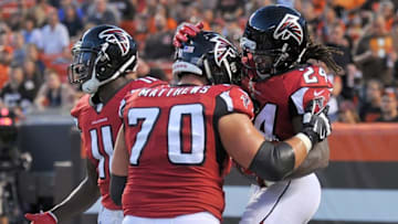 Aug 18, 2016; Cleveland, OH, USA; Atlanta Falcons running back Devonta Freeman (24) celebrates with tackle Jake Matthews (70) after a touchdown during the first quarter against the Cleveland Browns at FirstEnergy Stadium. Mandatory Credit: Ken Blaze-USA TODAY Sports