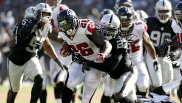 Sep 18, 2016; Oakland, CA, USA; Atlanta Falcons running back Tevin Coleman (26) scores a touchdown in front of Oakland Raiders free safety Reggie Nelson (27) in the fourth quarter at Oakland-Alameda County Coliseum. The Falcons defeated the Raiders 35-28. Mandatory Credit: Cary Edmondson-USA TODAY Sports