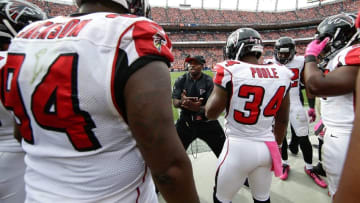 Oct 9, 2016; Denver, CO, USA; Atlanta Falcons secondary coach Marquand Manuel talks with defensive back Brian Poole (34) defensive end Tyson Jackson (94) and teammates in the second quarter against the Denver Broncos at Sports Authority Field at Mile High. The Falcons won 23-16. Mandatory Credit: Isaiah J. Downing-USA TODAY Sports
