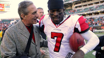 Atlanta Falcons owner Arthur Blank congratulates quarterback Michael Vick after defeating Cincinnati at Paul Brown Stadium in Cincinnati, Ohio on October 29, 2006. (Photo by Michael Hickey/Getty Images)