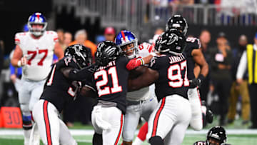 ATLANTA, GA - OCTOBER 22: Saquon Barkley #26 of the New York Giants is tackled by DeVondre Campbell #59, Desmond Trufant #21 and Grady Jarrett #97 of the Atlanta Falcons in the second quarter at Mercedes-Benz Stadium on October 22, 2018 in Atlanta, Georgia. (Photo by Scott Cunningham/Getty Images)