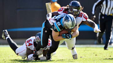 CHARLOTTE, NORTH CAROLINA - NOVEMBER 17: Takkarist McKinley #98 and Jermaine Grace #53 of the Atlanta Falcons tackle Christian McCaffrey #22 of the Carolina Panthers during the first quarter of their game at Bank of America Stadium on November 17, 2019 in Charlotte, North Carolina. (Photo by Grant Halverson/Getty Images)