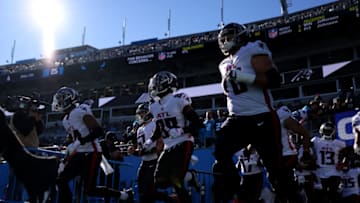 CHARLOTTE, NC - DECEMBER 12: Players of the Atlanta Falcons run onto the field prior to their game against the Carolina Panthers at Bank of America Stadium on December 12, 2021 in Charlotte, North Carolina. The Falcons won 29-21. (Photo by Lance King/Getty Images)
