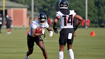 FLOWERY BRANCH, GA - JULY 29: Calvin Ridley #18 and Russell Gage #14 of the Atlanta Falcons participate in a drill on the first day of training camp at IBM Performance Field on July 29, 2021 in Flowery Branch, Georgia. (Photo by Edward M. Pio Roda/Getty Images)