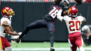 ATLANTA, GEORGIA - OCTOBER 03: Calvin Ridley #18 of the Atlanta Falcons attempts to make a catch against the defense of Bobby McCain #20 of the Washington Football Team inthe third quarter at Mercedes-Benz Stadium on October 03, 2021 in Atlanta, Georgia. (Photo by Kevin C. Cox/Getty Images)
