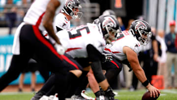 JACKSONVILLE, FLORIDA - NOVEMBER 28: Center Matt Hennessy #61 of the Atlanta Falcons waits to snap the ball to Matt Ryan #2 in the first half of the game against the Jacksonville Jaguars at TIAA Bank Field on November 28, 2021 in Jacksonville, Florida. (Photo by Douglas P. DeFelice/Getty Images)