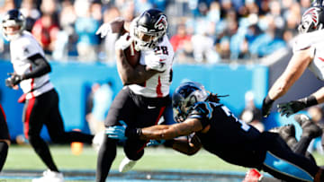 CHARLOTTE, NORTH CAROLINA - DECEMBER 12: Mike Davis #28 of the Atlanta Falcons rushes for a first down over the Atlanta Falcons in the first quarter of the game against the Carolina Panthers at Bank of America Stadium on December 12, 2021 in Charlotte, North Carolina. (Photo by Jared C. Tilton/Getty Images)