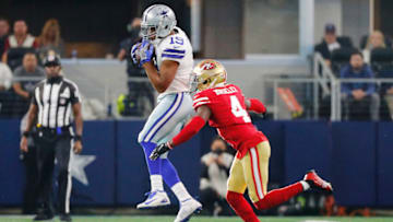 ARLINGTON, TEXAS - JANUARY 16: Amari Cooper #19 of the Dallas Cowboys catches a pass Emmanuel Moseley #4 of the San Francisco 49ers during the first half in the NFC Wild Card Playoff game at AT&T Stadium on January 16, 2022 in Arlington, Texas. (Photo by Richard Rodriguez/Getty Images)