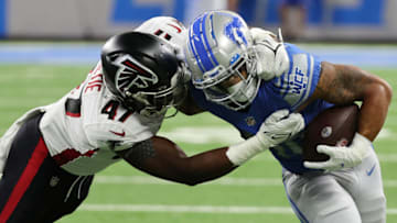 DETROIT, MICHIGAN - AUGUST 12: Craig Reynolds #46 of the Detroit Lions battles for yards while being tackled by Arnold Ebiketie #47 of the Atlanta Falcons during the first half during a NFL preseason game at Ford Field on August 12, 2022 in Detroit, Michigan. (Photo by Gregory Shamus/Getty Images)