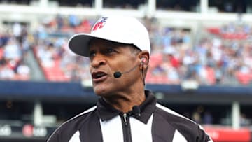 NASHVILLE, FL - SEPTEMBER 11: Referee Jerome Boger #123 flips a coin at midfield prior to an NFL football game between the New York Giants and the Tennessee Titans at Nissan Stadium on September 11, 2022 in Nashville, Tennessee. (Photo by Kevin Sabitus/Getty Images)