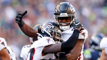 SEATTLE, WASHINGTON - SEPTEMBER 25: Richie Grant #27 of the Atlanta Falcons is congratulated by Jaylinn Hawkins #32 (R) after making an interception against the Seattle Seahawks during the fourth quarter at Lumen Field on September 25, 2022 in Seattle, Washington. (Photo by Steph Chambers/Getty Images)