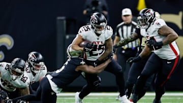 NEW ORLEANS, LOUISIANA - DECEMBER 18: Tyler Allgeier #25 of the Atlanta Falcons is tackled by Marcus Maye #6 of the New Orleans Saints during the first half at Caesars Superdome on December 18, 2022 in New Orleans, Louisiana. (Photo by Chris Graythen/Getty Images)