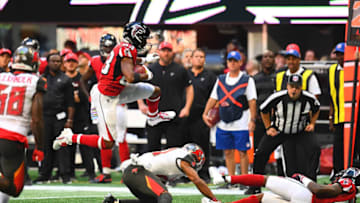 ATLANTA, GA - OCTOBER 14: Russell Gage #83 of the Atlanta Falcons hurdles over Justin Evans #21 of the Tampa Bay Buccaneers during the third quarter at Mercedes-Benz Stadium on October 14, 2018 in Atlanta, Georgia. (Photo by Scott Cunningham/Getty Images)
