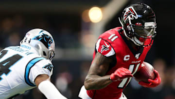 ATLANTA, GA - DECEMBER 8: Julio Jones #11 of the Atlanta Falcons rushes away from defender James Bradberry #24 of the Carolina Panthers during the second half of the game at Mercedes-Benz Stadium on December 8, 2019 in Atlanta, Georgia. (Photo by Carmen Mandato/Getty Images)