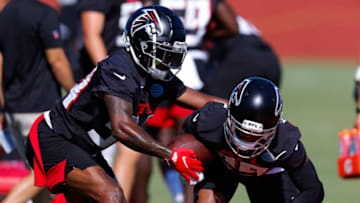 FLOWERY BRANCH, GA - JULY 28: Darren Hall #34 strips the ball from Casey Hayward #29 of Atlanta Falcons during a drill at training camp practice on July 28, 2022 at IBM Performance Field in Flowery Branch, Georgia. (Photo by Todd Kirkland/Getty Images)