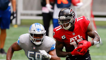 ATLANTA, GEORGIA - OCTOBER 25: Julio Jones #11 of the Atlanta Falcons makes a reception with Reggie Ragland #59 of the Detroit Lions in pursuit during the first half at Mercedes-Benz Stadium on October 25, 2020 in Atlanta, Georgia. (Photo by Kevin C. Cox/Getty Images)