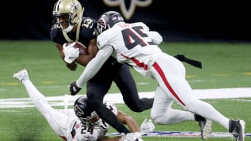 NEW ORLEANS, LOUISIANA - NOVEMBER 22: Michael Thomas #13 of the New Orleans Saints makes the catch as A.J. Terrell #24 and Deion Jones #45 of the Atlanta Falcons defend in the first quarter at Mercedes-Benz Superdome on November 22, 2020 in New Orleans, Louisiana. (Photo by Chris Graythen/Getty Images)