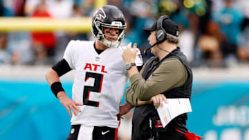 JACKSONVILLE, FLORIDA - NOVEMBER 28: Matt Ryan #2 and head coach Arthur Smith of the Atlanta Falcons talk on the side line during the fourth quarter against the Jacksonville Jaguars at TIAA Bank Field on November 28, 2021 in Jacksonville, Florida. (Photo by Douglas P. DeFelice/Getty Images)