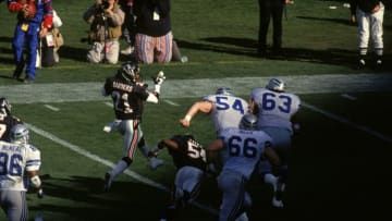ATLANTA, GA - DECEMBER 15: Deion Sanders #21 of the Atlanta Falcons highsteps as he returns a lateral from an interception against the Seattle Seahawks in an NFL game at the Fulton County Stadium on December 15, 1991 in Atlanta, Georgia. The Falcons defeated the Seahawks 26-13. (Photo by Gin Ellis/Getty Images)