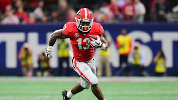 ATLANTA, GA - DECEMBER 01: Elijah Holyfield #13 of the Georgia Bulldogs runs with the ball in the second half against the Alabama Crimson Tide during the 2018 SEC Championship Game at Mercedes-Benz Stadium on December 1, 2018 in Atlanta, Georgia. (Photo by Scott Cunningham/Getty Images)