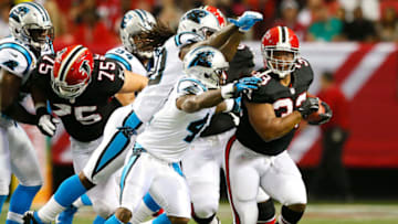 ATLANTA, GA - SEPTEMBER 30: Michael Turner #33 of the Atlanta Falcons rushes away from Captain Munnerlyn #41 of the Carolina Panthers at Georgia Dome on September 30, 2012 in Atlanta, Georgia. (Photo by Kevin C. Cox/Getty Images)