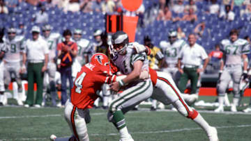 ATLANTA, GA - OCTOBER 3: John Walton #11 of the Philadelphia Eagles gets sacked by Fulton Kuykendall #54 of the Atlanta Falcons during an NFL football game October 3, 1976 at Atlanta-Fulton County Stadium in Atlanta, Georgia. Schmitt played for the Jets from 1967-73. (Photo by Focus on Sport/Getty Images)