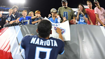 Aug 18, 2018; Nashville, TN, USA; Tennessee Titans quarterback Marcus Mariota (8) gives his towel to a young fan after the game against the Tampa Bay Buccaneers at Nissan Stadium. Mandatory Credit: Christopher Hanewinckel-USA TODAY Sports