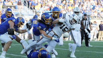 South Dakota State’s Christian Rozeboom and Jordan Brown (bottom) coral Montana State’s Troy Anderson (15) during the first quarter of the Jackrabbits’ matchup against the Bobcats Saturday night at Dana J. Dykhouse Stadium in Brookings. Jason Salzman For The Argus LeaderImg 0146South Dakota States Christian Rozeboom and Jordan Brown (bottom) coral Montana States Troy Anderson (15) during the first quarter of the Jackrabbits matchup against the Bobcats Saturday night at Dana J. Dykhouse Stadium in Brookings. Jason Salzman For The Argus Leader