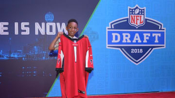 Jan 29, 2019; Atlanta, GA, USA; A young fan poses with the a No. 1 jersey of the Atlanta Falcons at the NFL Draft set at the Super Bowl LIII Experience at the Georgia World Congress Center. Mandatory Credit: Kirby Lee-USA TODAY Sports
