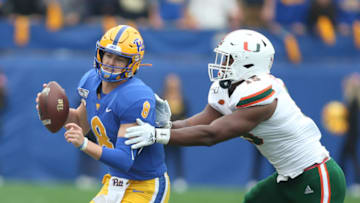 Oct 26, 2019; Pittsburgh, PA, USA; Pittsburgh Panthers quarterback Kenny Pickett (8) is chased by Miami Hurricanes defensive lineman Gregory Rousseau (15) during the first quarter at Heinz Field. Mandatory Credit: Charles LeClaire-USA TODAY Sports