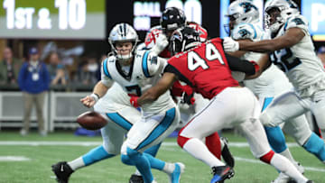 Dec 8, 2019; Atlanta, GA, USA; Carolina Panthers quarterback Kyle Allen (7) fumbles the ball defended by Atlanta Falcons defensive end Vic Beasley (44) in the third quarter at Mercedes-Benz Stadium. The Carolina Panthers recovered the fumble on the play. Mandatory Credit: Jason Getz-USA TODAY Sports