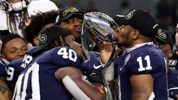 Dec 28, 2019; Arlington, Texas, USA; Penn State Nittany Lions linebacker Micah Parsons (11) and linebacker Jesse Luketa (40) kiss the Cotton Bowl trophy after the game against the Memphis Tigers at AT&T Stadium. Mandatory Credit: Kevin Jairaj-USA TODAY Sports